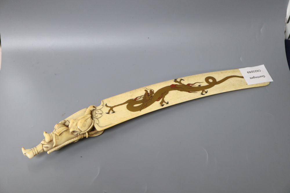 A carved ivory letter opener, with hand painted enamel gilt dragon, length 34cm